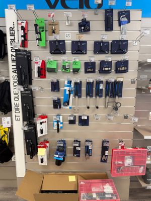 a display of various cell phones on the wall in a store