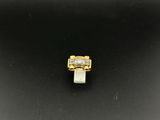 a gold and diamond ring on a black surface