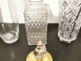 three glass vases on the table next to each other