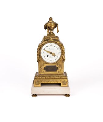 an image of a gold clock with a bird on top of it