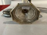 silver plated clock on a stand with a chain around it