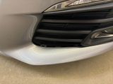 a close up of a car ' s front grill and headlight