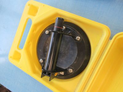 a yellow box with a black handle on it