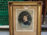 an old picture of a young boy in a gold frame