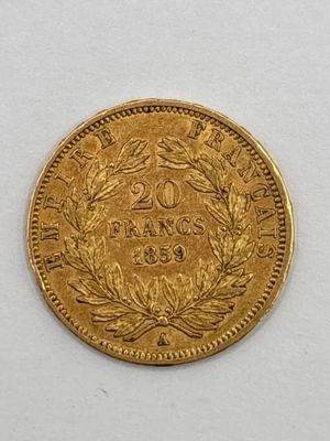 a close up of a gold coin on a white surface
