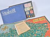 a board game set up on a table next to a book