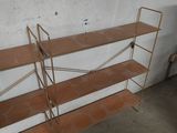 two shelvings in a room with a white wall and a brown floor