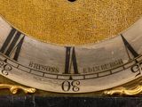 a clock with roman numerals on the face of it