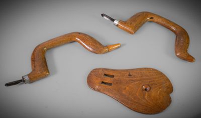 two pieces of wood sit on top of a table next to a pair of scissors