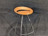 a stool with a wooden seat on a gray background