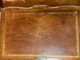 an old wooden desk with a clock on top of it