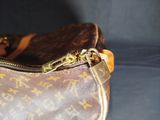 a brown and tan purse with a zipper on it