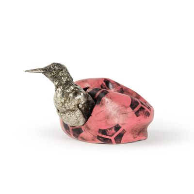 un oiseau perché sur un objet rose