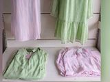 three dresses on display on a shelf in a store