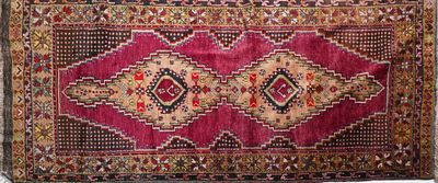 a red rug with a diamond design on it