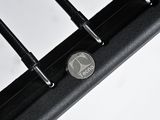 a close up of a metal grill grate with a coin on top of it