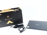 an open box with a laptop and a charger on it