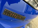 a close up of a sticker on the front of a blue car