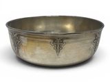 an antique silver bowl with a decorative design on the rim