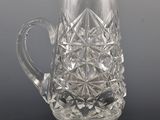 a glass pitcher that is sitting on a table