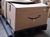 a box with a smile drawn on it sitting on a pallet in a warehouse