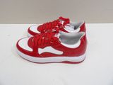 a pair of red and white sneakers on a white surface