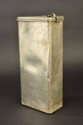 an old silver metal box sitting on top of a black surface