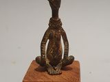 a small statue of a monkey sitting on a block
