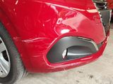 a close up of a red car in a garage