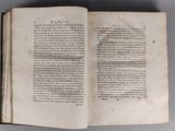 an open book with a page of text on it sitting on top of a table