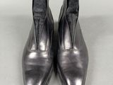 pair of black leather ankle boots with zippers on each side