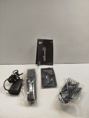 a box with a knife, scissors and other items on a table