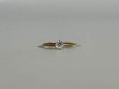 a close up of a diamond ring on a white surface