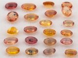 un assortiment de pierres précieuses de différentes couleurs posées sur une surface blanche