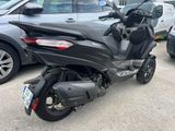 a motorcycle parked in a parking lot next to a car