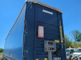 an image of a blue trailer parked in a parking lot