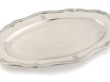 a silver plate with a decorative design on the edge