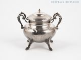 an antique silver plated teapot on stand with a lid
