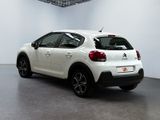 the rear of a white citrole parked in a white room