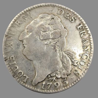 gros plan d'une pièce de monnaie sur laquelle figure un visage de femme