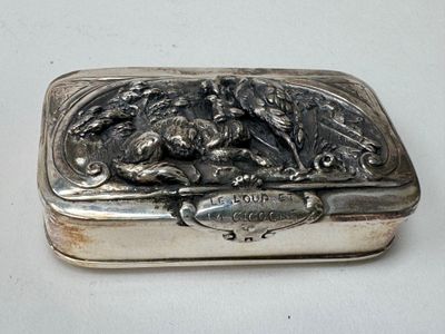 a silver box that has a picture of a dog on it