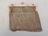 an old purse with a chain hanging from it ' s side
