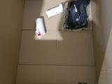a cardboard box with items inside of it on the floor