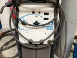 a machine that is sitting on the ground next to a pole