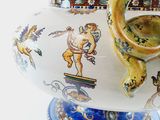 a vase with a handle that has a painting on it