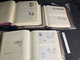 three open books with stamps on them sitting on a table