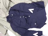 a pile of clothing that is laying on a bed