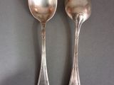 two spoons sitting next to each other on a table