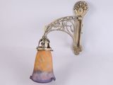 brass wall sconce with a glass shade on a white background