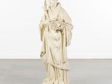 a white statue of a woman holding a bouquet of flowers